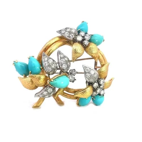 DIAMOND TURQUOISE GOLD BROOCH 18K TWO TONE FLOWER STYLE: DIAMOND TURQUOISE GOLD BROOCH 18K TWO TONE FLOWER STYLE This gorgeous brooch is crafted from 18k yellow and white gold featuring flowers on a double stem round frame, the petals of the flowers are cab