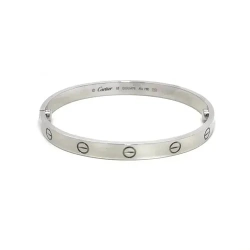 CARTIER LOVE GOLD BANGLE CLASSIC MODEL 18K WHITE SIZE 18 BOX CERT & PAPER: CARTIER LOVE GOLD BANGLE CLASSIC MODEL 18K WHITE SIZE 18 BOX CERT & PAPER This elegant bangle is by Cartier, from 18k white gold, it features a screw closure and signed by the brand. This classic mode