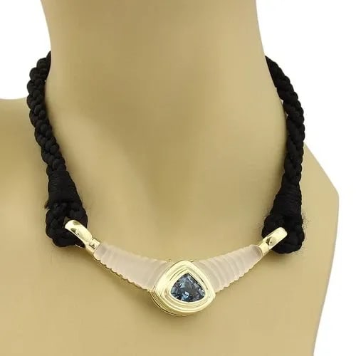 AQUAMARINE NECKLACE 18K YELLOW GOLD PENDANT WITH CORD: AQUAMARINE NECKLACE 18K YELLOW GOLD PENDANT WITH CORD This impressive Estate necklace has a long centerpiece crafted from 18k yellow gold in a high polished finish featuring a large trillion cut aquam