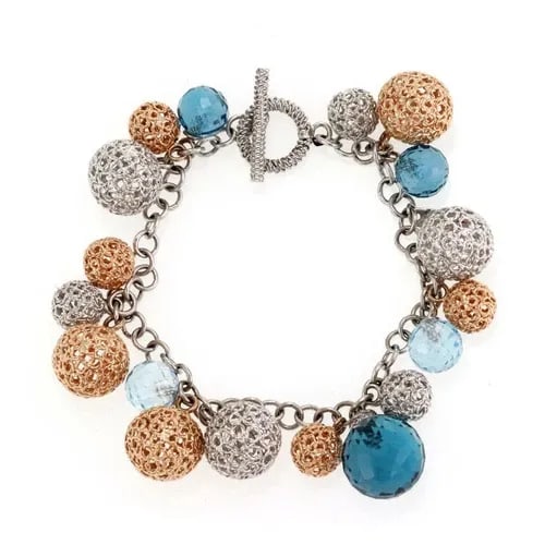 ROBERTO COIN BRACELET DIAMOND BEAD 18K GOLD FILIGREE BALL CHARMS: The Roberto Coin bracelet is a luxurious piece crafted from 18k gold with a beautiful combination of white diamonds and blue gemstones. This charms bracelet features a delicate design with intricate g