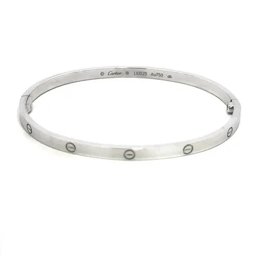 CARTIER LOVE GOLD BANGLE SMALL MODEL 18K WHITE SIZE 18 BOX & CERTIFICATE: CARTIER LOVE GOLD BANGLE SMALL MODEL 18K WHITE SIZE 18 BOX & CERTIFICATE This elegant bangle is by Cartier, from 18k white gold, it features a screw closure and signed by the brand. This small model b