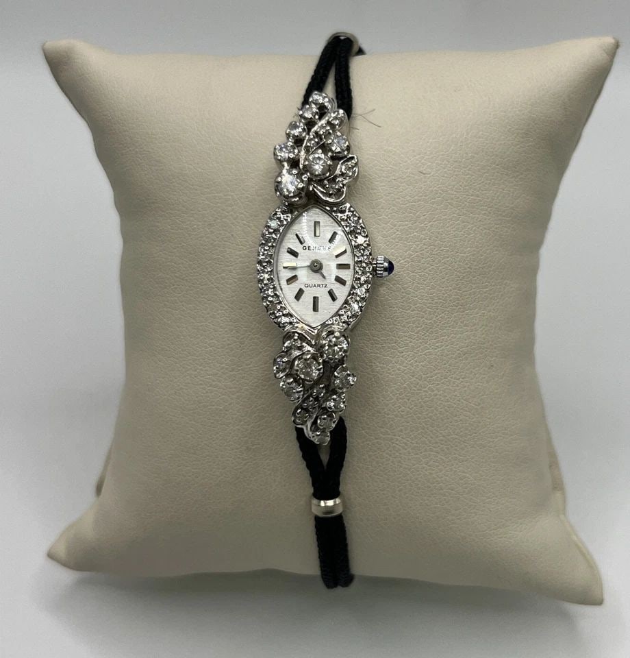 GENEVE LADIES DIAMOND AND 14K WHITE GOLD WATCH: GENEVE LADIES DIAMOND AND 14K WHITE GOLD WATCH GENEVE LADIES DIAMOND AND 14K WHITE GOLD WATCH 14K White Gold and Diamond Ladies Watch Approximate weight is 12.2g There are 36 round diamonds which weig