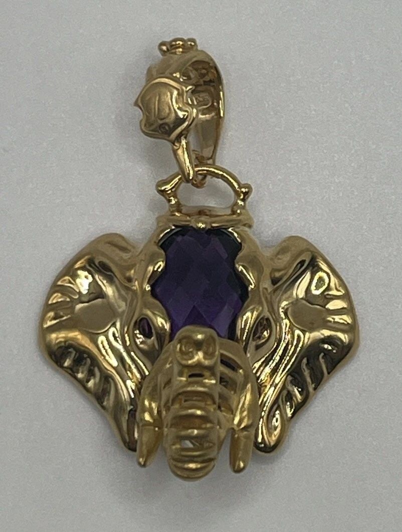 14K YELLOW GOLD WITH PURPLE STONE ELEPHANT PENDANT: 14K YELLOW GOLD WITH PURPLE STONE ELEPHANT PENDANT 14K YELLOW GOLD WITH PURPLE STONE ELEPHANT PENDANT Add a touch of elegance and beauty to your jewelry collection with this stunning 14K yellow gold p