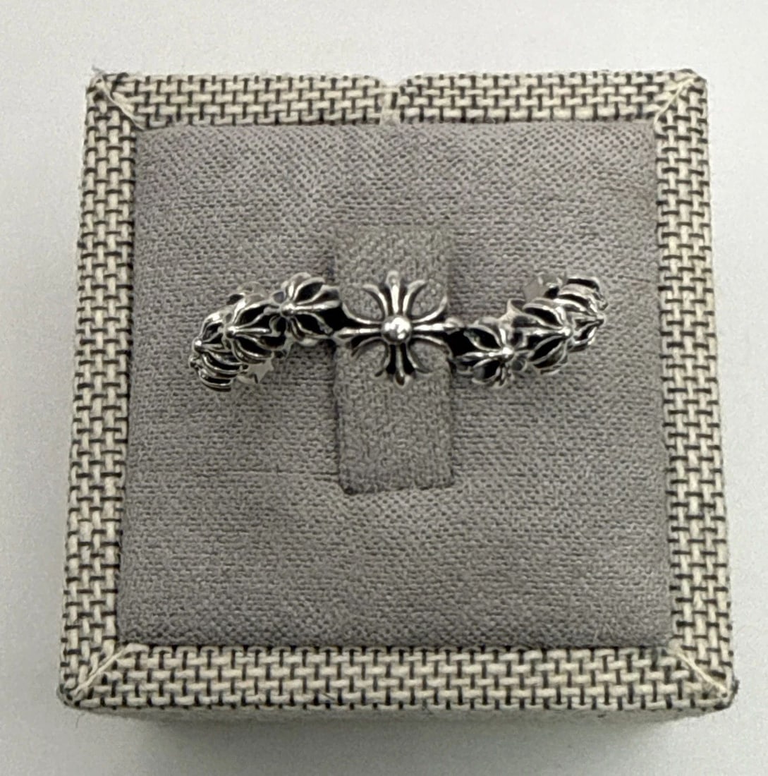CHROME HEARTS FLORAL/WAVE ETERNITY BAND RING SIZE 8 The Chrome Hearts Wave Ring in size 8 is a sleek: The Chrome Hearts Wave Ring in size 8 is a sleek and stylish piece of fine jewelry crafted from sterling silver with a 925 metal purity. This ring, designed by the popular brand Chrome Hearts, feature