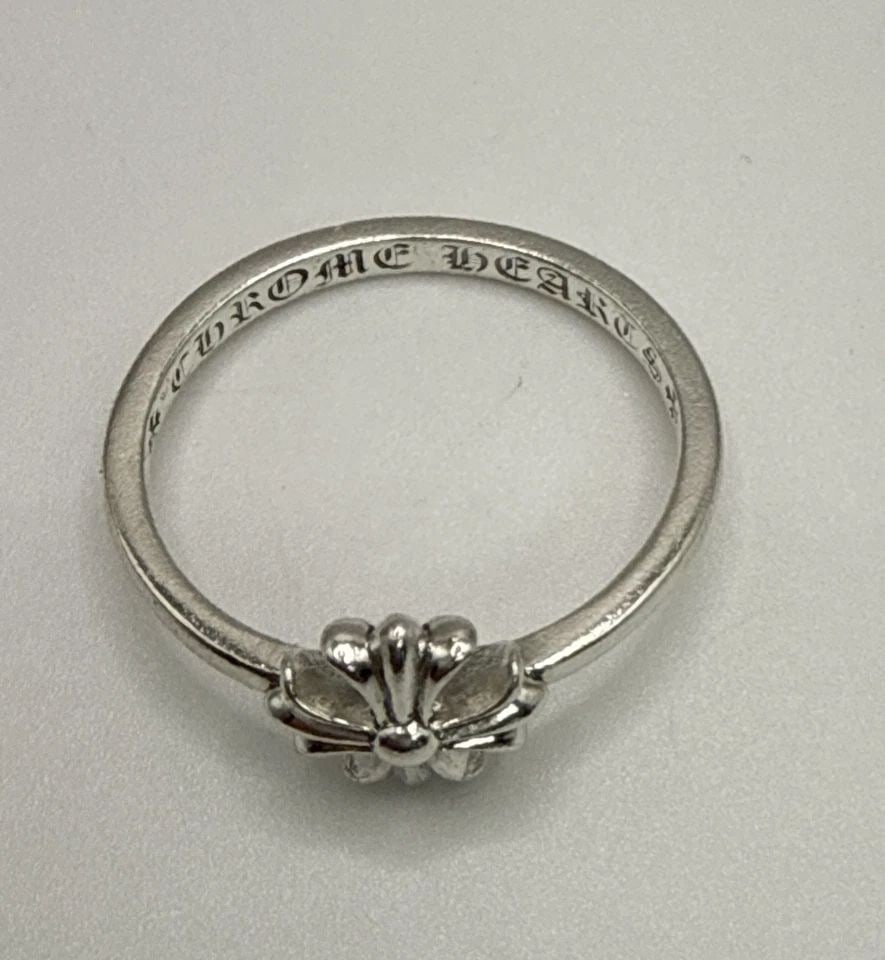 CHROME HEARTS PLUS BUBBLEGUM RING SIZE 7.5 The Chrome Hearts Plus Bubblegum Ring is a luxurious: The Chrome Hearts Plus Bubblegum Ring is a luxurious accessory crafted from sterling silver, featuring a size 7.5 ring band. This stylish ring is designed by the renowned brand Chrome Hearts, making i