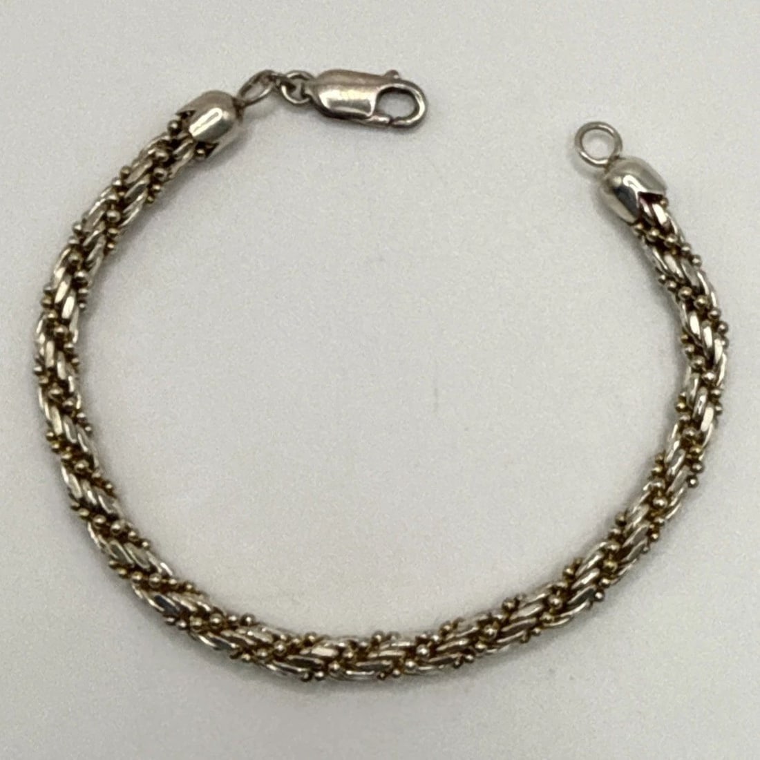 TWO TONE STERLING SILVER 7" BRACELET 16.4 GRAMS: TWO TONE STERLING SILVER 7" BRACELET 16.4 GRAMS This two-tone sterling silver 7" bracelet weighs 16.4 grams and features a classic chain style. Made from high-quality 925 sterling silver, this bracele