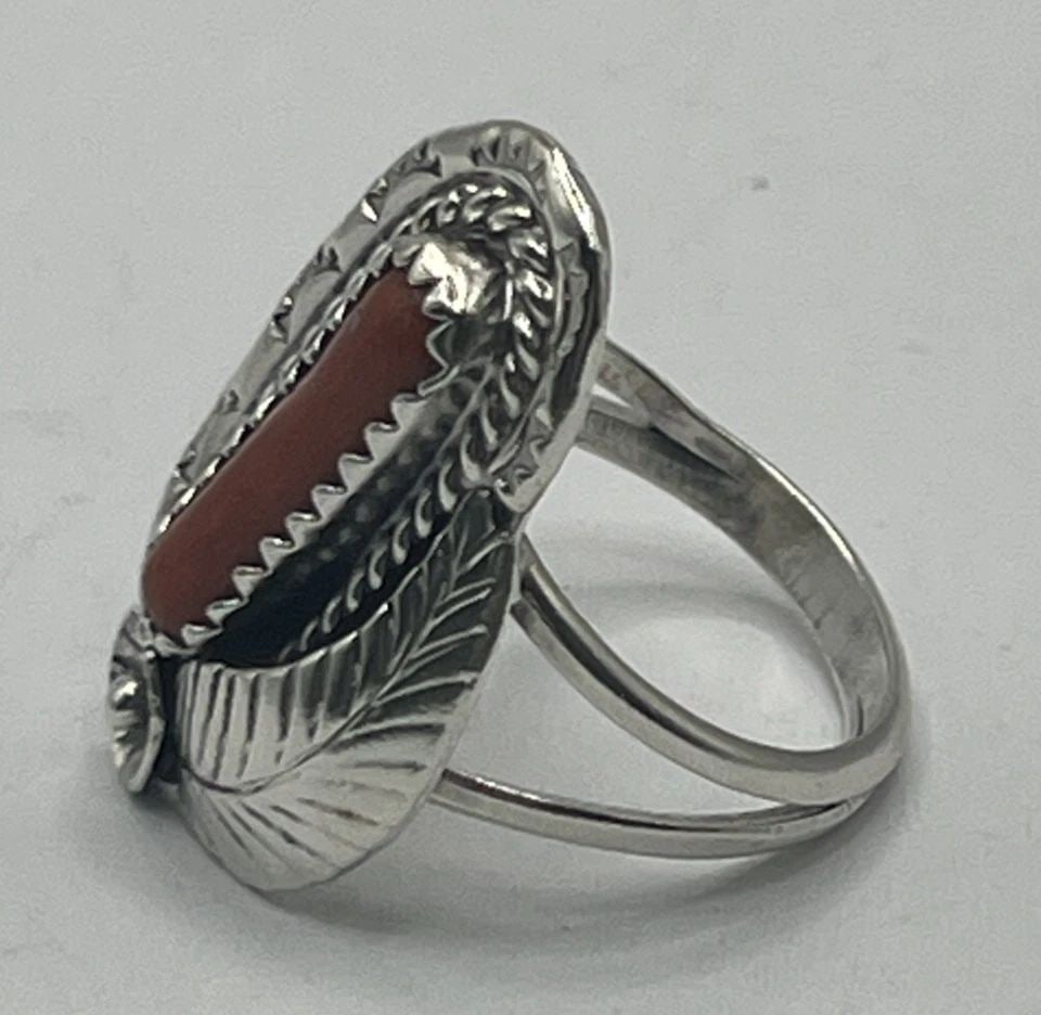 STERLING SILVER & CORAL SIZE 5.5: STERLING SILVER & CORAL SIZE 5.5 This is a beautiful Sterling Silver ring featuring a vibrant Coral gemstone in a size 5.5. The ring is crafted from 925 Sterling Silver, known for its durability and l