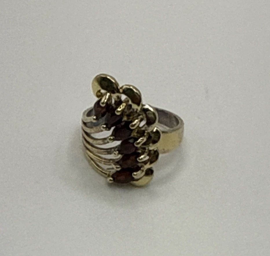 GOLD COLOR STERLING SILVER RING WITH RED STONES SIZE 5: GOLD COLOR STERLING SILVER RING WITH RED STONES SIZE 5 This product is a beautiful sterling silver ring with a gold color finish, featuring red stones as the main accent. The ring is size 5 and is cra