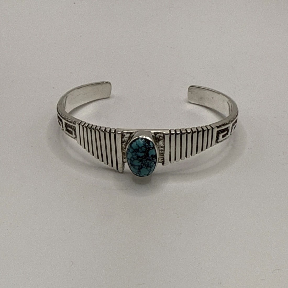 HENRY MARIANO DETAILED CAST STERLING SILVER & TURQUOISE CUFF BRACELET: HENRY MARIANO DETAILED CAST STERLING SILVER & TURQUOISE CUFF BRACELET The Henry Mariano Detailed Cast Sterling Silver & Turquoise Cuff Bracelet is a stunning piece of Native American jewelry crafted w