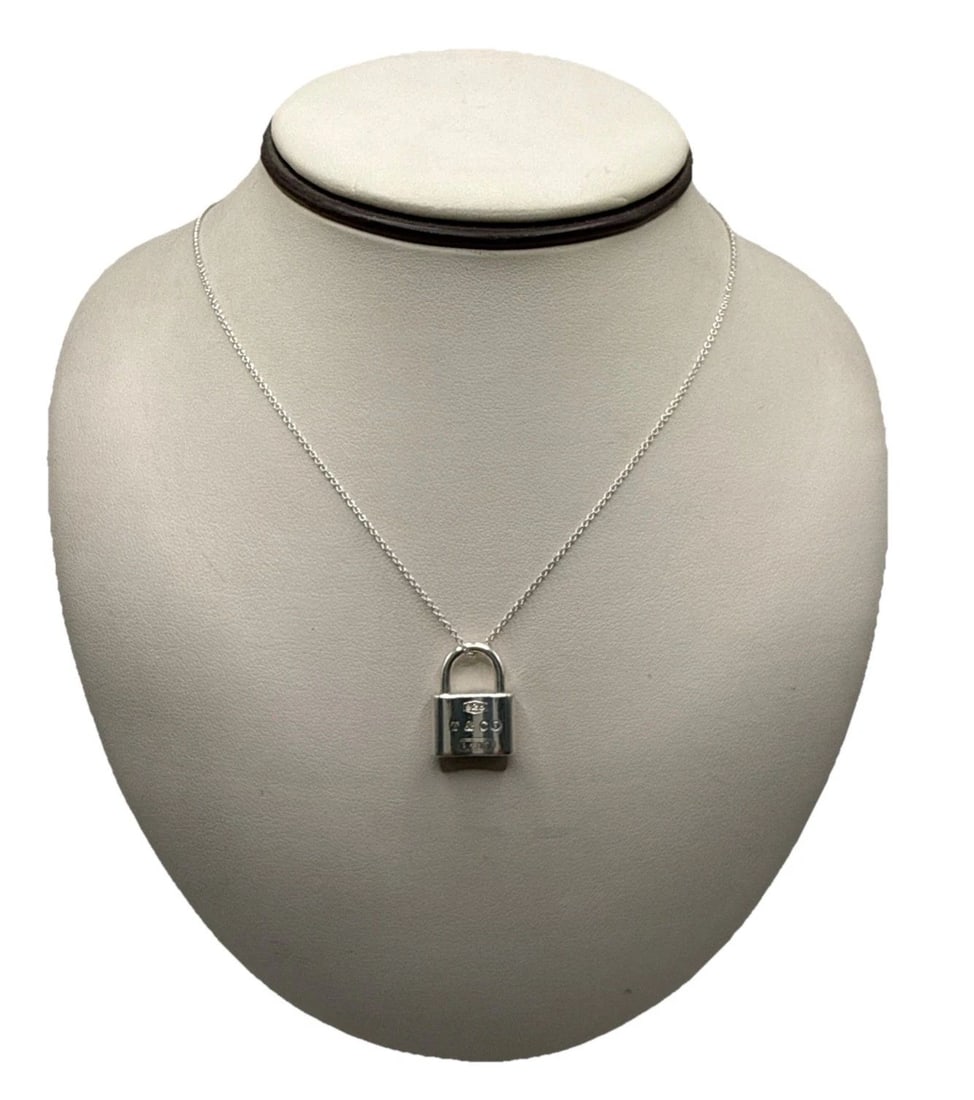 925 TIFFANY & CO. 1837 PADLOCK PENDANT ON 18" CHAIN: 925 TIFFANY & CO. 1837 PADLOCK PENDANT ON 18" CHAIN The 925 Tiffany & Co. 1837 Padlock Pendant on 18" Chain is a luxurious piece of fine jewelry that exudes elegance and sophistication. Made of sterli