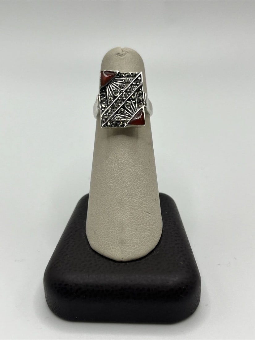 STERLING SILVER WITH MARCASITE AND CORAL SIZE 6 RING: STERLING SILVER WITH MARCASITE AND CORAL SIZE 6 RING STERLING SILVER WITH MARCASITE AND CORAL SIZE 6 RING This beautiful ring in size 6 is perfect for adding a pop of color to any outfit. Made of high