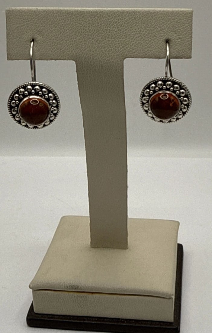 STERLING SILVER & AMBER HANGING EARRINGS: STERLING SILVER & AMBER HANGING EARRINGS STERLING SILVER & AMBER HANGING EARRINGS 5.6 grams These Sterling Silver & Amber Hanging Earrings feature a beautiful dangle/drop style with vibrant orange amb