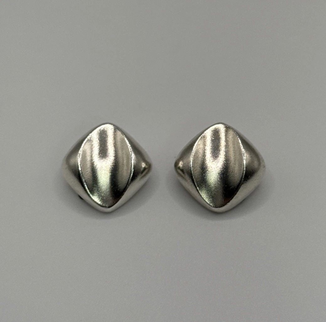 STERLING SILVER SQUARE CLIP-ON EARRINGS These Sterling Silver Square Clip-On Earrings are a stylish: These Sterling Silver Square Clip-On Earrings are a stylish and elegant addition to any jewelry collection. Made from 925 sterling silver, these stud earrings feature a sleek square shape that adds a 