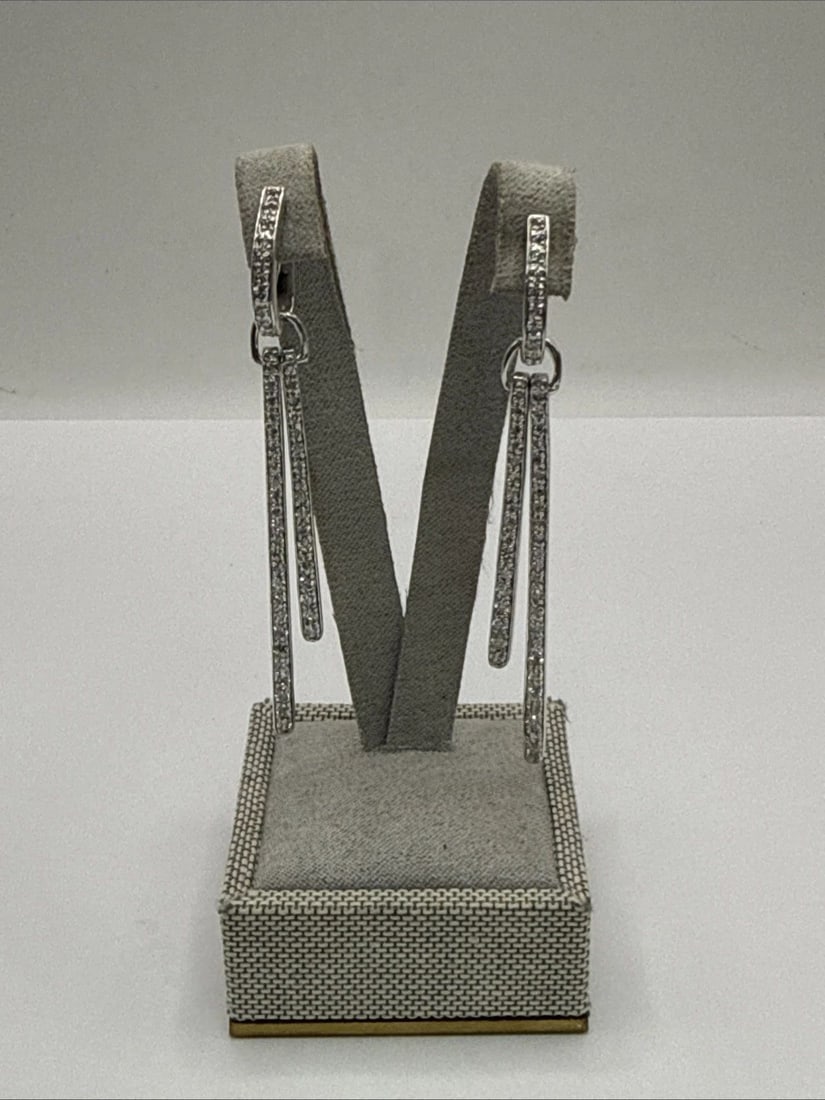STERLING SILVER LONG BAR DROP EARRINGS WITH COLORLESS STONES: STERLING SILVER LONG BAR DROP EARRINGS WITH COLORLESS STONES These Sterling Silver Long Bar Drop Earrings feature a sleek and elegant design, perfect for adding a touch of sophistication to any outfit