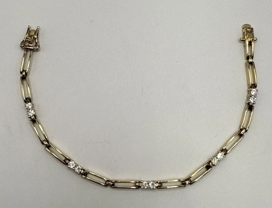 7.5" GOLD COLORED 925 BRACELET WITH COLORLESS STONES: 7.5" GOLD COLORED 925 BRACELET WITH COLORLESS STONES This 7.5" gold colored bracelet features 925 sterling silver with colorless stones set in a chain style design. The elegant and timeless piece of f