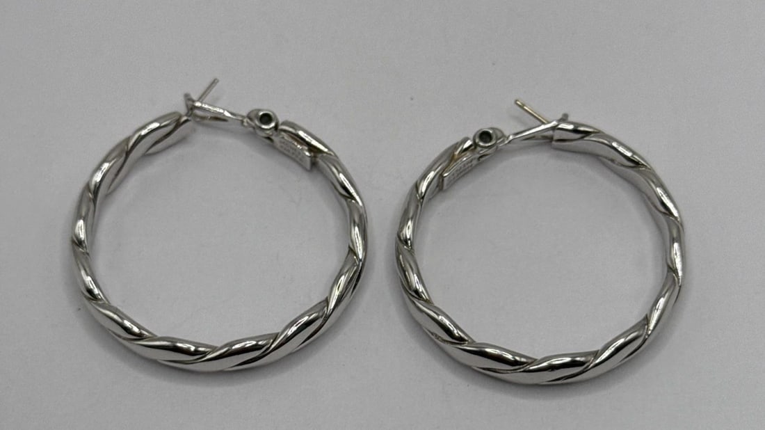 1 1/2" MONET BRAIDED BAND PIERCED HOOP EARRINGS SILVER PLATED: 1 1/2" MONET BRAIDED BAND PIERCED HOOP EARRINGS SILVER PLATED 1 1/2" MONET BRAIDED BAND PIERCED HOOP EARRINGS SILVER PLATED Elevate your jewelry collection with these classic 1 1/2" Monet braided band