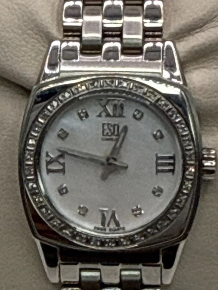 16" STERLING SILVER CHAIN WITH COLORLESS STONE CROSS The ESQ Ladies Stainless Steel Quartz Diamond: The ESQ Ladies Stainless Steel Quartz Diamond Bezel Mother of Pearl Dial Watch is a stylish and elegant timepiece designed for women. With a silver bezel and a Mother of Pearl dial featuring Arabic nu