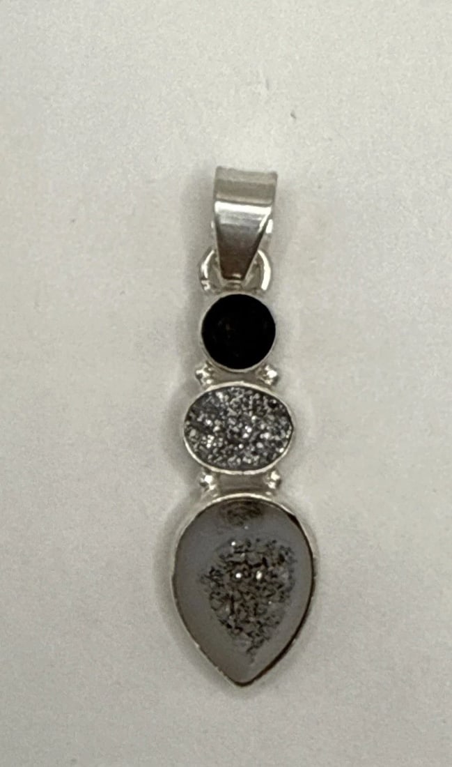 STERLING SILVER PENDANT WITH THREE TIERED STONES: STERLING SILVER PENDANT WITH THREE TIERED STONES The Sterling Silver Pendant with Three Tiered Stones is a beautifully crafted piece of fine jewelry that exudes elegance and sophistication. Made with