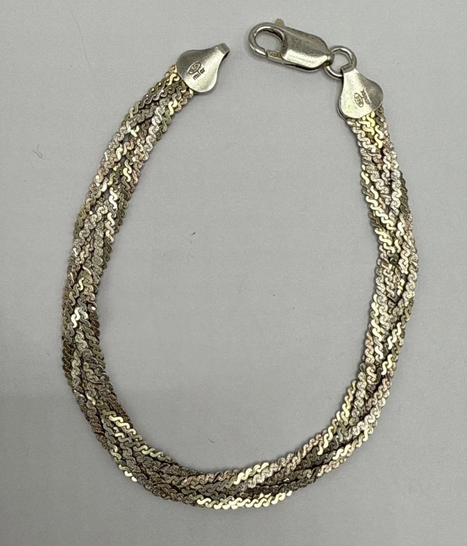 7" STERLING SILVER BRAIDED BRACELET 7.9 GRAMS: 7" STERLING SILVER BRAIDED BRACELET 7.9 GRAMS This 7" Sterling Silver Braided Bracelet is a stylish and elegant piece of fine jewelry. Made with high-quality 925 sterling silver, the bracelet features