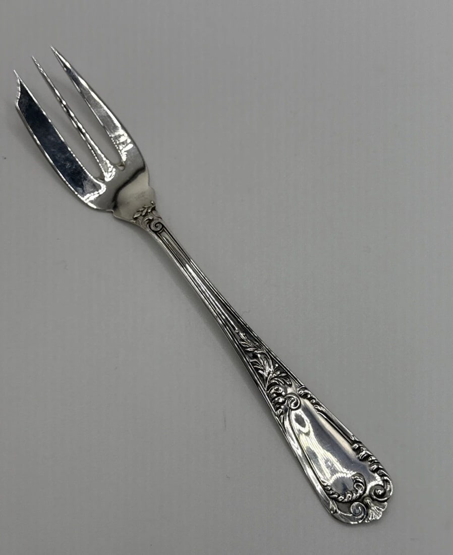 800 SILVER COCKTAIL / DESSERT FORK 5.5"IN: 800 SILVER COCKTAIL / DESSERT FORK 5.5"IN The product is a luxurious 800 silver cocktail/dessert fork that measures 5.5 inches in length. Made of sterling silver, this elegant fork is perfect for serv