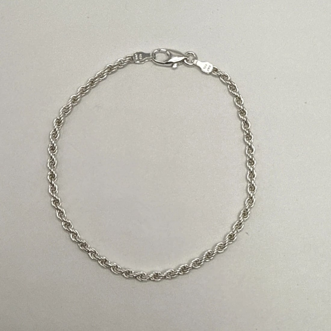 7" STERLING SILVER ROPE BRACELET: 7" STERLING SILVER ROPE BRACELET This 7" Sterling Silver Rope Bracelet is a classic piece of fine jewelry that exudes elegance and sophistication. Crafted from high-quality 925 sterling silver, this c