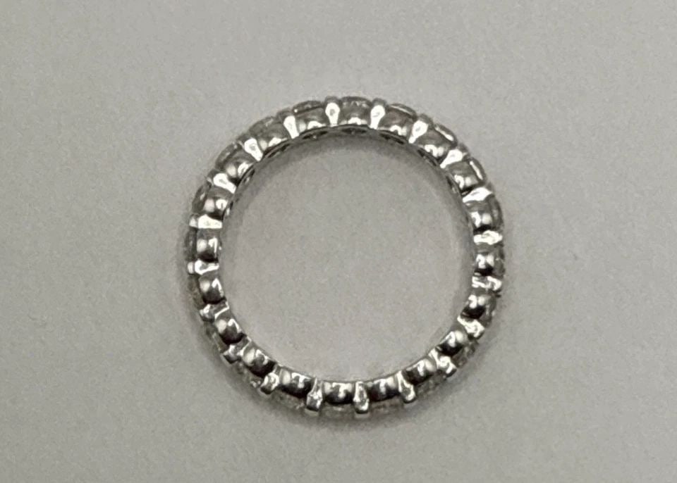 STERLING SILVER AND COLORLESS STONE ETERNITY BAND SIZE 7: STERLING SILVER AND COLORLESS STONE ETERNITY BAND SIZE 7 2.7 grams This Sterling Silver and Colorless Stone Eternity Band in size 7 is a timeless and elegant piece of fine jewelry. With a metal purity