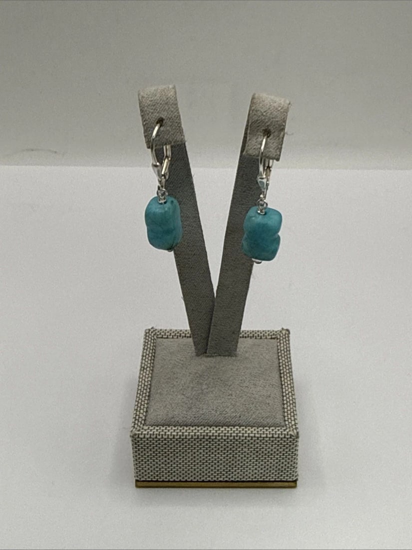 STERLING SILVER & TURQUOISE NUGGET DANGLE EARRINGS: STERLING SILVER & TURQUOISE NUGGET DANGLE EARRINGS These Sterling Silver & Turquoise Nugget Dangle Earrings are sure to make a statement with their unique and eye-catching design. The earrings feature