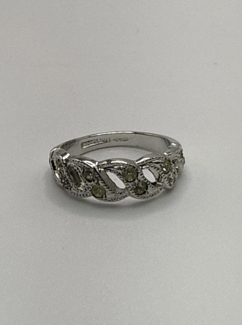 STERLING SILVER SIZE 4 RING WITH COLORLESS STONES: STERLING SILVER SIZE 4 RING WITH COLORLESS STONES This product is a size 4 ring made of 925 sterling silver. It features colorless stones set in the silver band, adding a touch of elegance to any