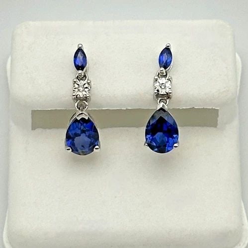 10K WHITE GOLD EARRING, LAB CREATED SAPPHIRES AND NATURAL DIAMONDS 1.7 GRAMS: 10K WHITE GOLD EARRING WITH LAB CREATED SAPPHIRES AND 0.01CTS NATURAL DIAMONDS 10k White Gold Earring with Lab Created Sapphires and 0.01cts natural Diamonds Condition: Used, has been cleaned Material