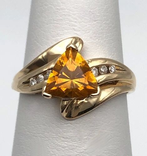 14K GOLD RING WITH TRILLION CUT CITRINE AND 0.06CTW DIAMONDS (SIZE 5.5) 2.4 GRAM: 14k Gold Ring with trillion cut Citrine and 0.06cts of Diamonds Condition: Used at some point, has been cleaned Material: 14k Yellow Gold Ring Size: 5.5 Weight: 2.4 grams Top Width: 11.8mm Bottom Widt