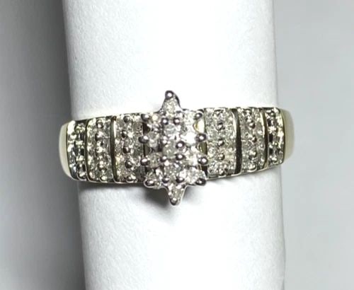 NEW 10K GOLD RING WITH MARQUISE HEAD AND 0.25CTW DIAMONDS (SIZE 7) 2.7 GRAM: WOMEN'S 10K YELLOW GOLD RING WITH 0.25CT DIAMONDS (SIZE 7) Women's 10k Yellow Gold Ring with 0.25CT Diamonds (Size 7) You are bidding on a new with tags Women's 10k Yellow Gold Ring with 0.25CT Diamon