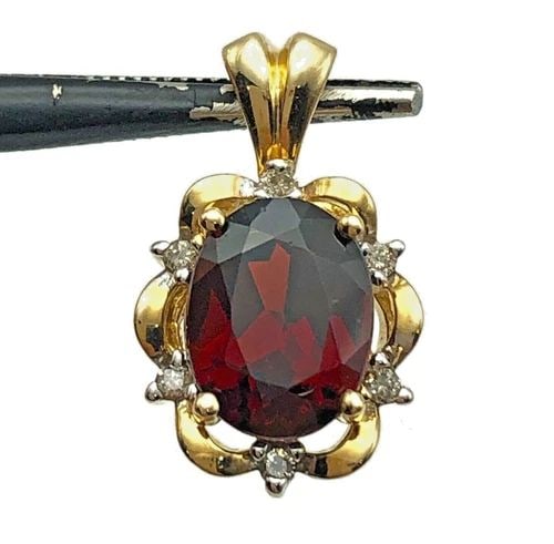 14K GOLD PENDANT WITH OVAL GARNET AND 0.06CTS OF DIAMONDS 2 GRAMS: 14K GOLD PENDANT WITH OVAL GARNET AND 0.06CTS OF DIAMONDS 2 GRAMS 14k Gold Pendant with oval Garnet and 0.06cts of Diamonds Condition: Used Material: 14k Yellow Gold Pendant Size: 18mm x 11mm Total We