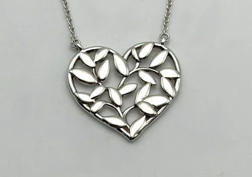 TIFFANY & CO. PALOMA PICASSO 925 SILVER OLIVE LEAF HEART PENDANT AND CHAIN 18": Tiffany & Co. Paloma Picasso Olive Leaf Heart Pendant and Chain Condition: Used Material: 925 Sterling Silver Necklace Size: 18 inches long, 0.5mm wide Pendant Size: 18mm x 16mm , measured at it's fur