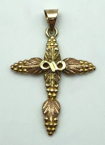 10K BLACK HILLS GOLD CROSS PENDANT WITH 14K GOLD BAIL 1.6 GRAMS: 10K BLACK HILLS GOLD CROSS PENDANT WITH 14K GOLD BAIL 1.6 GRAMS 10k Black Hills Gold Cross Pendant with 14k Gold Bail Condition: Used Material: 10k Black Hills Gold, with 14k Gold Bail Pendant Size: 3