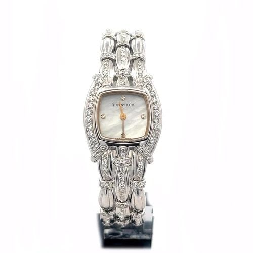 TIFFANY & CO. DIAMOND GOLD WATCH 18K WHITE LADIES MOP DIAL QUARTZ: TIFFANY & CO. DIAMOND GOLD WATCH 18K WHITE LADIES MOP DIAL QUARTZ This is a gorgeous lady's wristwatch; it is crafted from 18k white gold featuring the case and triple row band decorated with diamonds
