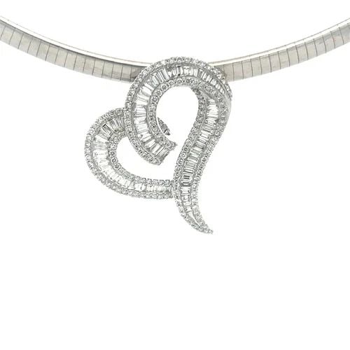 DIAMOND GOLD NECKLACE 18K WHITE OMEGA HEART SLIDE PENDANT: This gorgeous necklace features an 18k white gold omega necklace with a stunning curved heart shape pendant with channel set baguette diamonds and round diamonds decorating along both ends of the hear