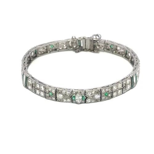 ART DECO DIAMOND PLATINUM EMERALD BRACELET FILIGREE MILGRAIN GEMSTONE: ART DECO DIAMOND PLATINUM EMERALD BRACELET FILIGREE MILGRAIN GEMSTONE This Art Deco diamond platinum bracelet features a floral design with intricate filigree and milgrain details. The entire length b