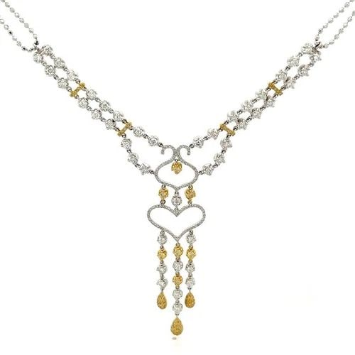 GOLD DOUBLE NECKLACE HEART 18K PENDANT DIAMOND OPEN DELICATE DESIGN: GOLD DOUBLE NECKLACE HEART 18K PENDANT DIAMOND OPEN DELICATE DESIGN This is a lavish two tone 18k gold, fancy yellow and white diamonds ladies cocktail necklace. The piece is exquisitely crafted in 18