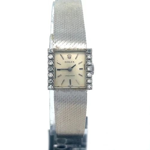 ROLEX PRECISION VINTAGE GOLD WATCH 18K WHITE DIAMOND SQUARE MANUAL WIND: The lovely Rolex Precision vintage hold watch is a luxurious timepiece for women, featuring a square 18k white gold case with a diamond bezel and stick indexes. This manual wind Swiss-made watch has a