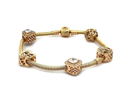 4907 PANDORA 14K YELLOW GOLD 5 SLIDE CHARMS SNAKE CHAIN BRACELET: 4907 PANDORA 14K YELLOW GOLD 5 SLIDE CHARMS SNAKE CHAIN BRACELET From the Classic Collection by Pandora, this 14k yellow gold snake chain bracelet has 5 slide charms, hearts, box round and ball shape,