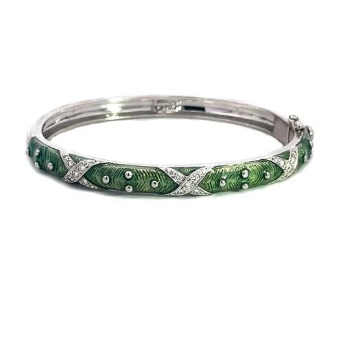 HIGALGO DIAMOND GOLD BANGLE ENAMEL 18K WHITE X STYLE WIDE OVAL SHAPE: The Higalgo gold bangle features a stunning oval shape, it is hinged on one end with slide closure on the other side. The bangle is crafted with 18k white gold, the front half has green guilloche enam