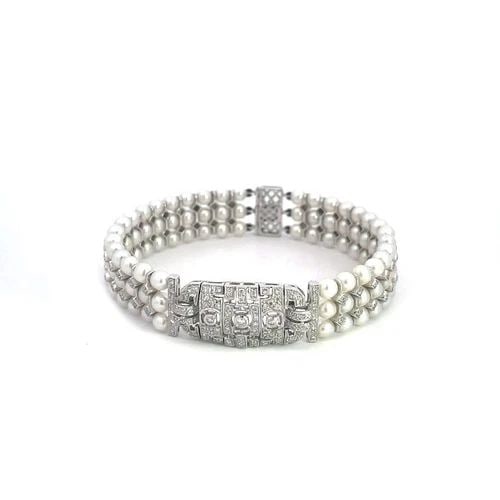DIAMOND PEARLS 18K ESTATE WHITE GOLD CENTER MOTIF TRIPLE ROW BRACELET: DIAMOND PEARLS 18K ESTATE WHITE GOLD CENTER MOTIF TRIPLE ROW BRACELET This beautiful estate bracelet is crafted from 18k white gold featuring an open design long rectangle shape center motif decorated