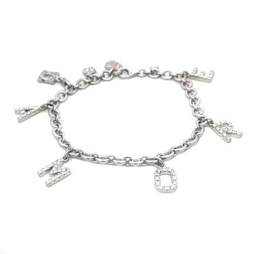 DODO GOLD DIAMOND BRACELET BY POMELLATO 18K WHITE AMORE CHARMS DANGLE STYLE: The romantic piece is from Dodo by Pomellato, it is a luxurious piece of fine jewelry crafted from in white gold featuring a charming dangle style with 5 letter spelled AMORE and 3 charms all with pav