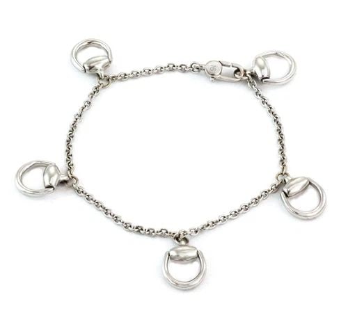 GUCCI 18K WHITE GOLD 5 HORSEBIT DANGLE CHARMS CHAIN BRACELET LIQUIDATION: GUCCI 18K WHITE GOLD 5 HORSEBIT DANGLE CHARMS CHAIN BRACELET Gucci 18k White Gold 5 Horsebit Dangle Charms Chain Bracelet Description This is an elegant authentic bracelet from Gucci, it is crafted fr
