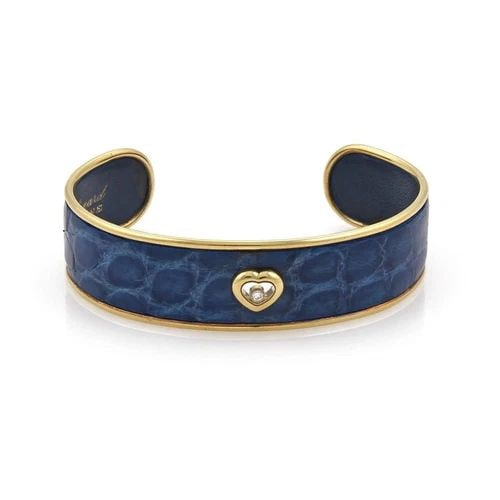 CHOPARD HAPPY DIAMOND BRACELET 18K GOLD HEART BLUE LEATHER CUFF: CHOPARD HAPPY DIAMOND BRACELET 18K GOLD HEART BLUE LEATHER CUFF Chopard Happy Diamond 18k Gold Heart Blue Leather Cuff Bracelet Description This chic authentic cuff bracelet is by Chopard from the Hap