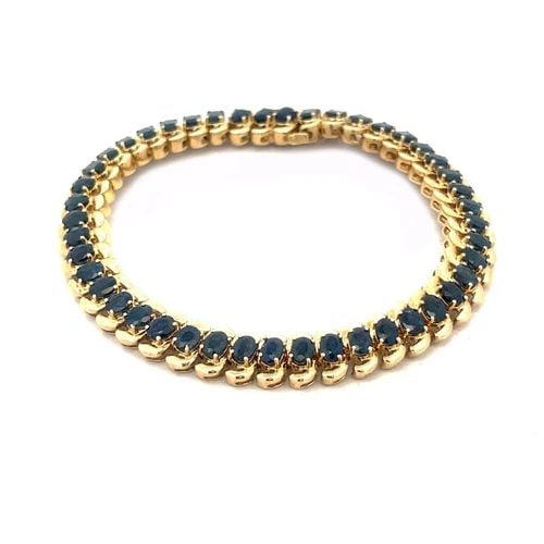 SAPPHIRE 14K GOLD BRACELET S LINK YELLOW FLEX LINK OVAL CUT: SAPPHIRE 14K GOLD BRACELET S LINK YELLOW FLEX LINK OVAL CUT This lovely bracelet is crafted from 14k yellow gold featuring polished chasing S links with an oval shape prong set sapphire gemstone attac