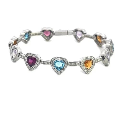 DIAMOND GOLD BRACELET 14K WHITE MULTI-COLOR GEMSTONE HEART LINK STYLE: This lovely hearts and bar link bracelet is crafted from 14k white gold, each heart has a bezel set colored gemstone with diamond bezel and each bar has prong set diamonds. The bracelet secures with a