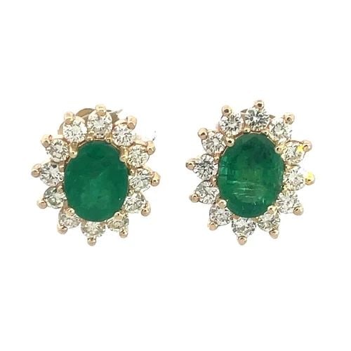 EMERALD GOLD EARRINGS DIAMOND 14K YELLOW OVAL PRONG HALO STUD: These stunning pair of earrings are crafted from 14k yellow gold featuring an oval shape prong set brilliant diamonds in a halo style around a magnificent oval cut grass green emerald gemstone. With i