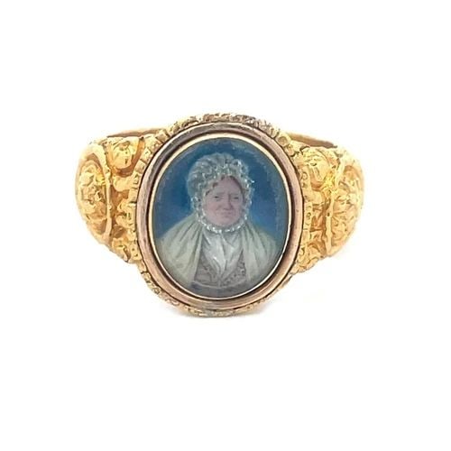 EDWARDIAN 22K GOLD RING PAINTED WOMAN PORTRAIT DEEP RELIEF FLORAL STYLE: The product is a vintage 22k gold ring from the Edwardian era, featuring an oval shaped painted woman portrait. The wide shank and tapered band has deep relief floral design. This unique ring is perfe