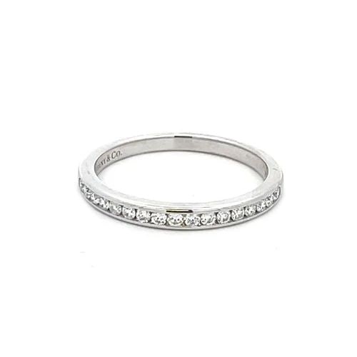 TIFFANY & CO. WEDDING BAND DIAMOND PLATINUM RING: TIFFANY & CO. WEDDING BAND DIAMOND PLATINUM RING Authentic and elegant from Tiffany & Co. This delicate feminine band is crafted from platinum with a high polished finish. The front half of the band h